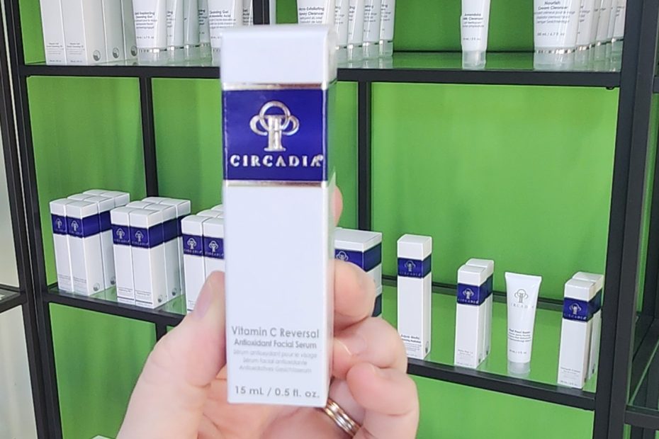 Windy Linde holding a bottle of Vitamin C Reversal Serum at Linde Esthetics and Wellness Studio in Springfield Mo
