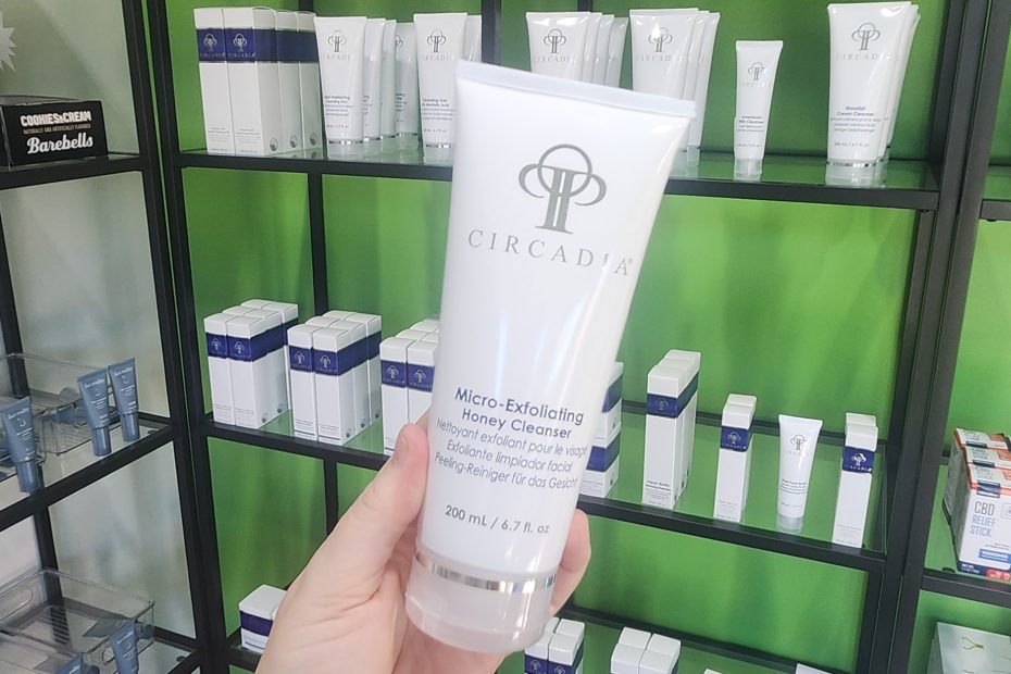 Windy Linde holding a bottle of Circadia Micro-Exfoliating Honey Cleanser at Linde Esthetics & Wellness Studio in Springfield MO