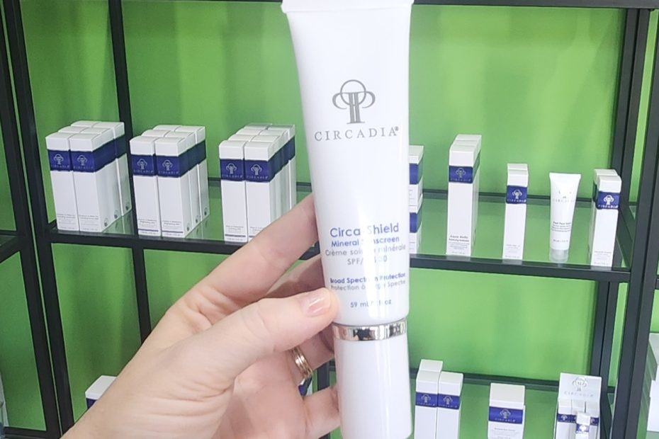 Windy Linde holding a tube of Circadia Circa-Shield Mineral Sunscreen at Linde Esthetics & Wellness Studio
