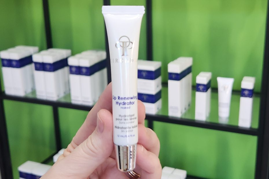 Windy Linde is holding a tube of Circadia Lip Renewing Hydrator in Naked at Linde Esthetics & Wellness Studio in Springfield MO
