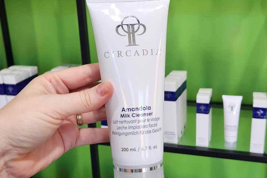 Windy Linde holding a tube of Amandola Milk Cleanser at Linde Esthetics & Wellness Studio in Springfield MO