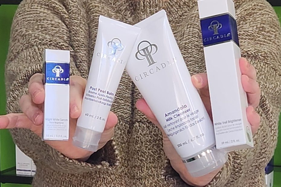 Windy Linde is hold four Circadia Skincare products. Inclided are Post Peel Balm, Amamdola Milk Cleanser, Bright White Serum and White Veil Brightener. She is in the lobby at Linde Esthetics & Wellness Studio in Springfield MO.