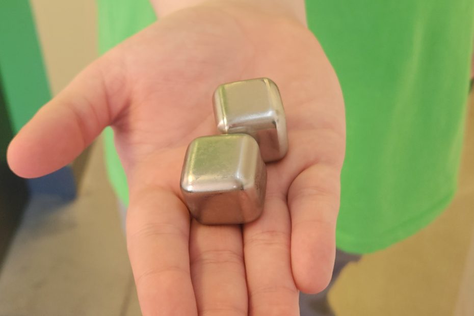 Person holding cold whiskey cubes in their hand. Used for icing breakouts and reducing inflammation.